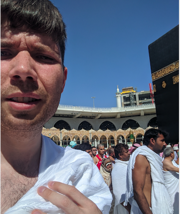Me wearing white ihram clothing in front of the kaaba