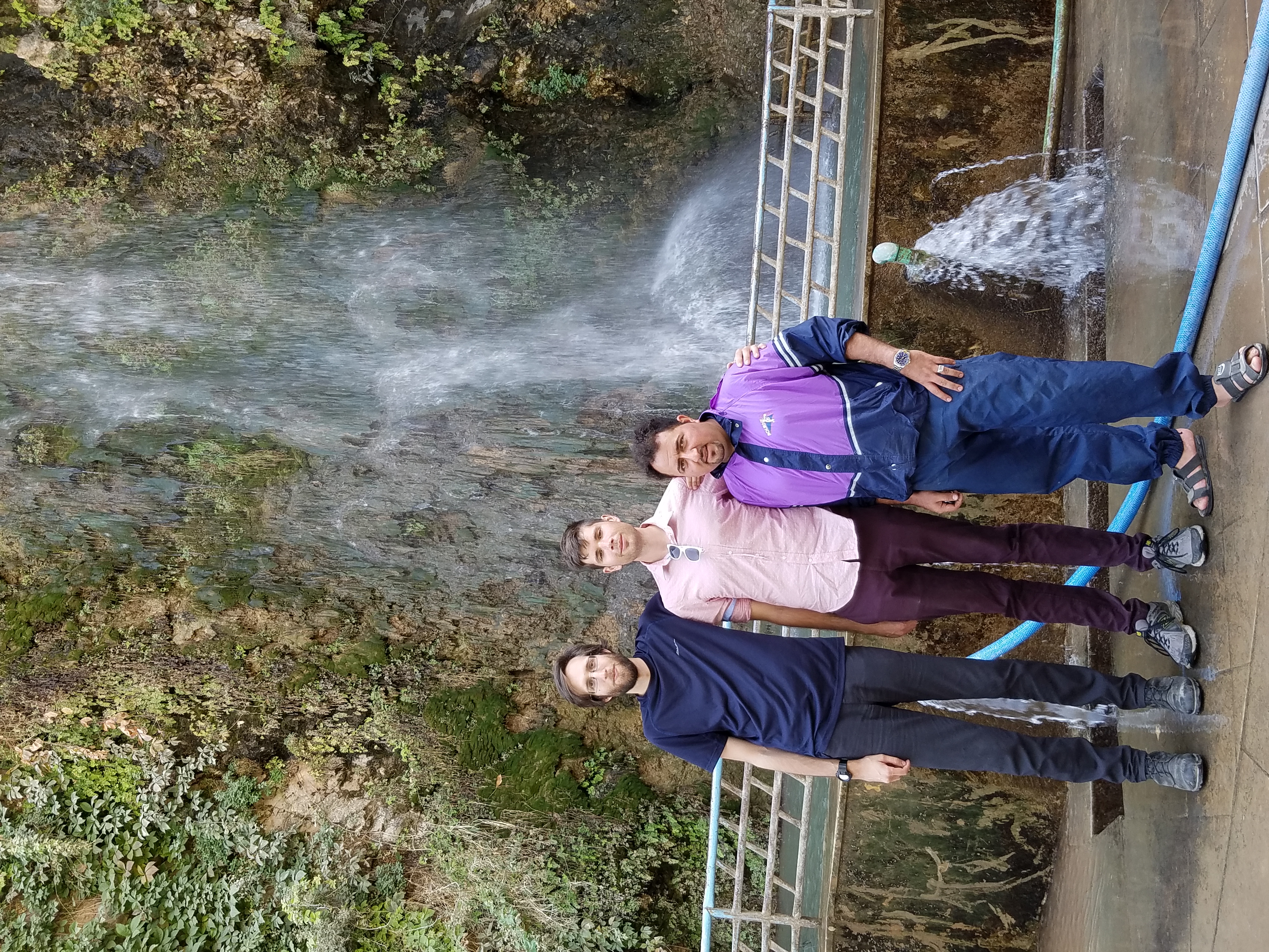 Eason, Cameron, and Hiwa standing in front of a waterfall