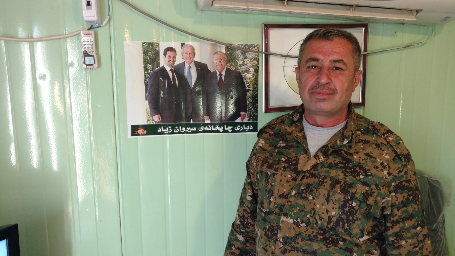 peshmerga soldier in front of a picture of George W Bush. Source: self